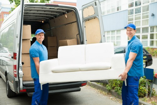 Professional movers handling office furniture