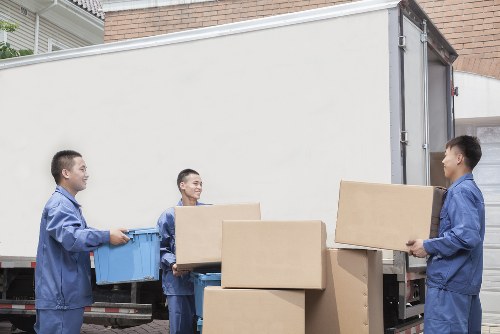 Removal van parked on a London street in front of terraced houses