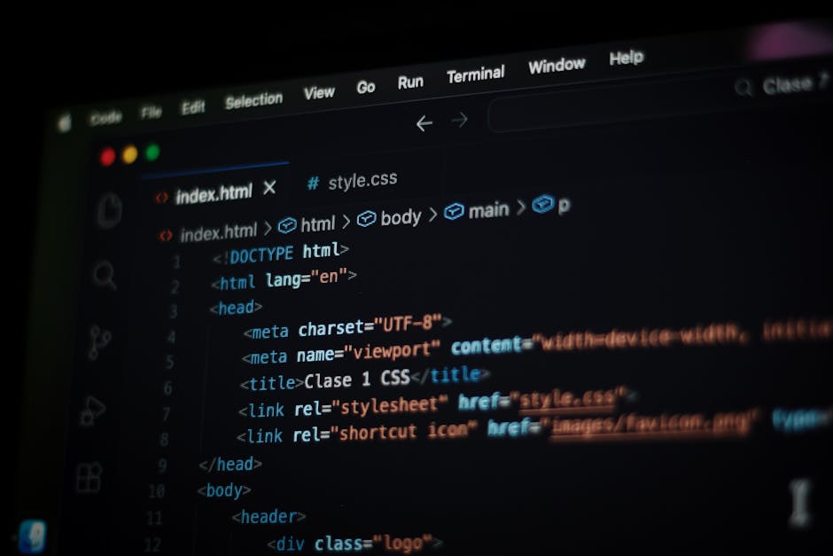 A computer screen displaying a code editor with HTML and CSS code visible, featuring lines of code such as meta tags, title, and stylesheet links. The screen is part of a workspace where web developme